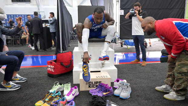 John Wall unpacks several pairs of shoes.